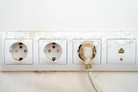 Dirty dust on the power socket or connector and electric wire in the room. re Stock Photos