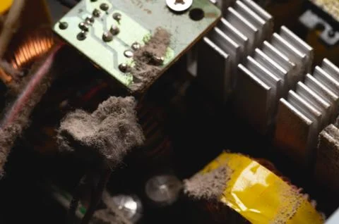 Dirty elements of the pc power supply in dust. Aluminum radiator with pieces of Stock Photos