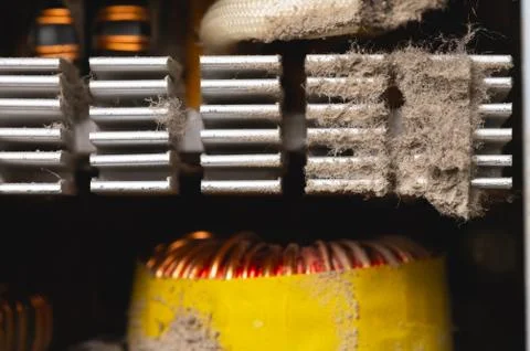 Dirty elements of the pc power supply in dust. Aluminum radiator with pieces of Stock Photos
