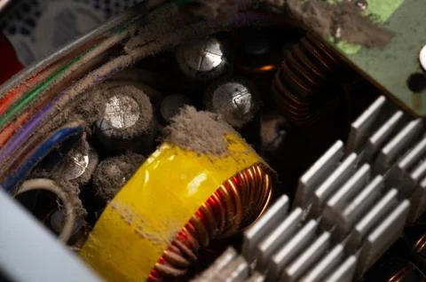 Dirty elements of the pc power supply in dust. Aluminum radiator with pieces of Stock Photos