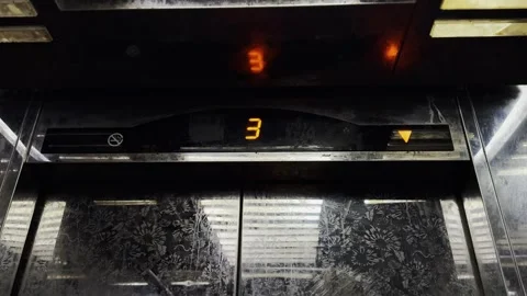 Dirty elevator floor indicator changing from 7 to G as doors open inside Stock Footage 328591372