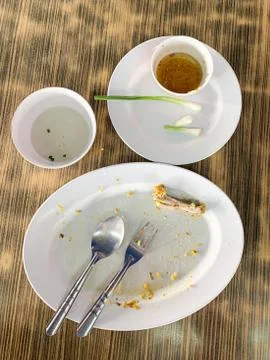Dirty empty dish with spoon and fork Stock Photos