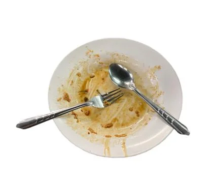 Dirty empty dish with spoon and fork Stock Photos