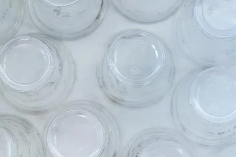 Dirty empty plastic glasses on a white background, top view, close up. Stock Photos