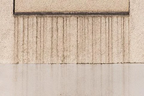 Dirty facade plastered structure and beige painted rendered old over time Stock Photos