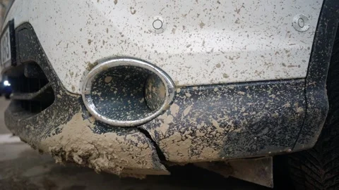 Dirty front bumper of modern white suv car parked on city street with mud s.. Stock Footage 339778348