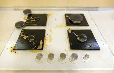 Dirty gas hob in the kitchen. The concept of removing grease stains. Stock Photos
