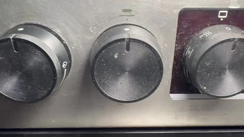 Dirty gas stove knobs and front panel - handheld close-up Stock-Footage 317770258