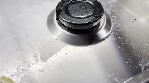 Dirty greasy chrome cooker surface in the kitchen, dried greasy stains and Stock Footage 270056195