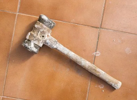 Dirty hammer on tile background Stock Photos