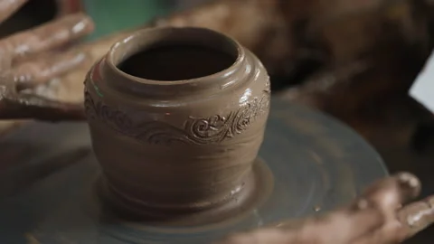 Dirty hands in mud working on artistic clay pot in workshop Stock Footage 304223347