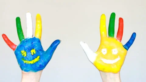 Dirty hands painted different colors with smiles. The concept of happiness, good Video stock 88345861