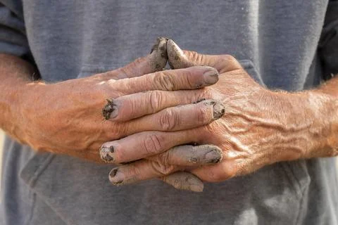 Dirty hands of the worker.Male hands in cement close-up. Stock Photos