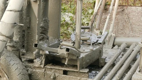Dirty installation drills a hole in the ground 스톡 동영상 105680150