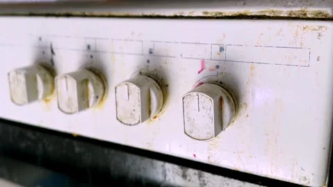 Dirty Kitchen Stove Control Knobs on Greasy Oven Front Panel Close-Up Stock Footage 330925657