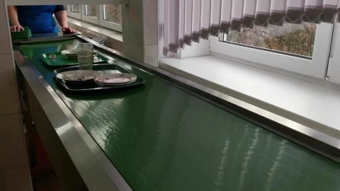 Dirty kitchen trays move on a motorized conveyor belt Stock Footage 324761788
