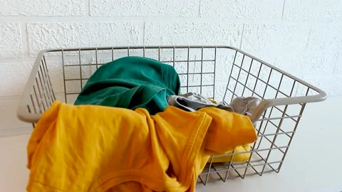 Dirty laundry is thrown into laundry basket. Stock Footage 157794133