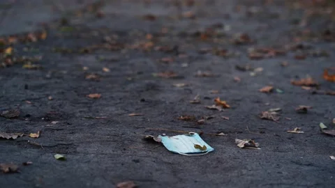 Dirty mask is lying on the road Stock Footage 142203637