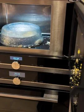Dirty microwave cover after exploded egg, kitchen cleaning concept. Stock Photos