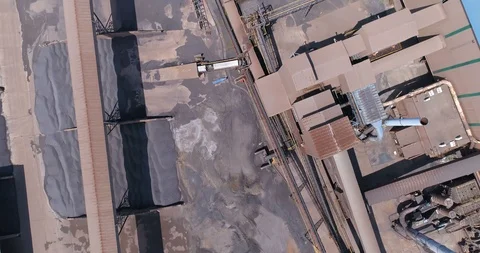 Dirty mine smelter complex viewed from above with conveyor passages over dump 스톡 동영상 85957487