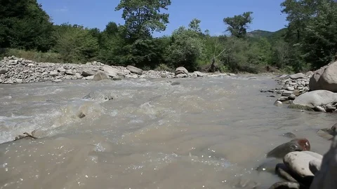 Dirty mountain river flowing Stock Footage 81776586