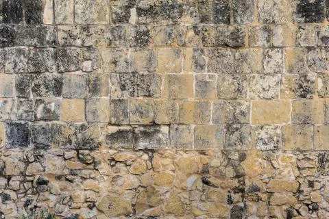 Dirty old building bricks wall made of limestone Stock Photos