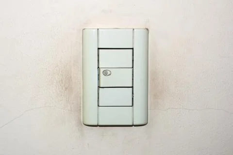 Dirty, old light switch on a cracked, weathered wall. Photos