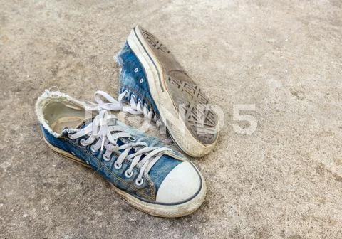 Dirty old shoes on the floor Stock Photos