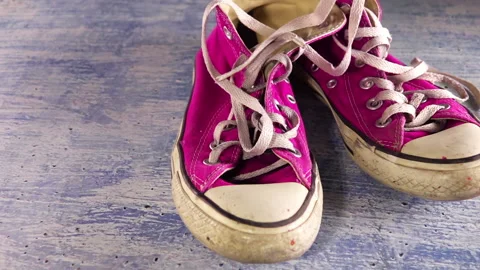 Dirty Old Sneakers and Shoelaces. Slow Motion Stock Footage