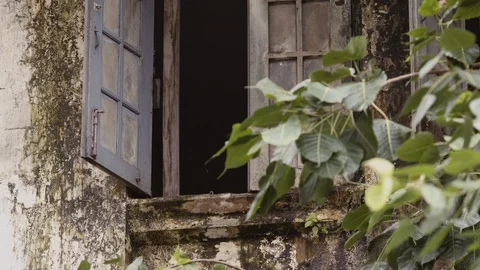 Dirty open window and mossy balcony in a town in Myanmar Video stock 95619941