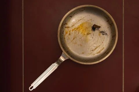 Dirty pan with extinguished cigarette. Stock Photos
