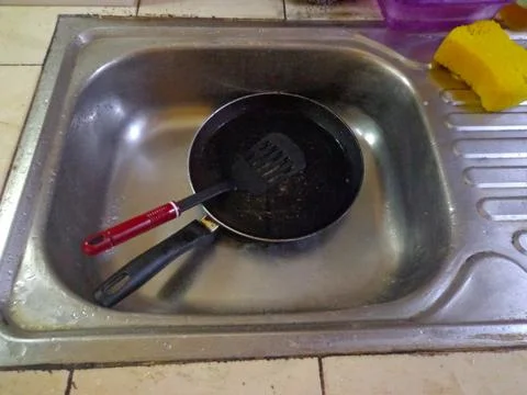 Dirty pans in the kitchen sink Stock Photos