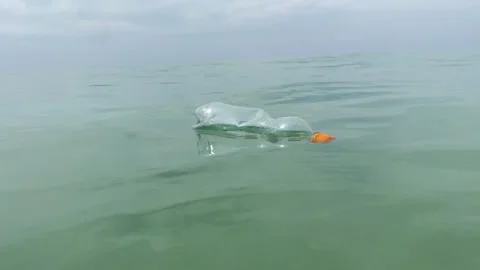 Dirty plastic bottle floating in the sea Stock Footage 277608337