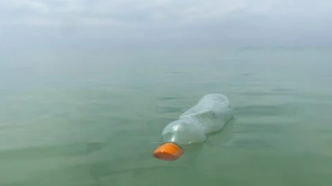 Dirty plastic bottle floating in the sea Stock Footage 277608385