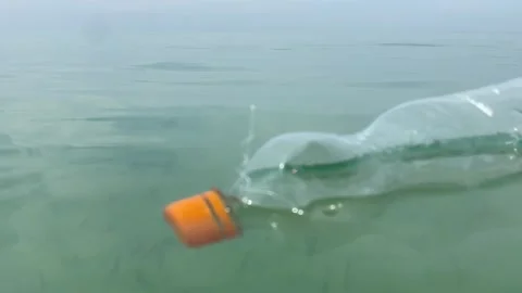 Dirty plastic bottle floating in the sea Stock Footage 277608431