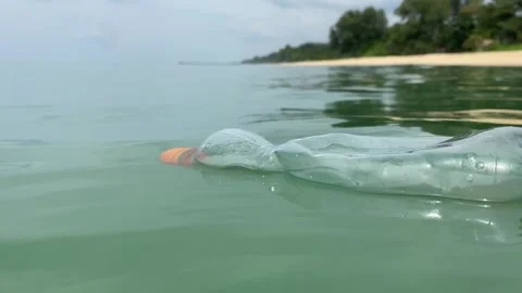 Dirty plastic bottle floating in the sea Stock Footage 277608520