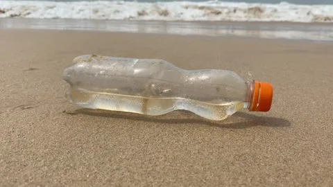 Dirty plastic bottle washed up on the beach Stock Footage 277608196