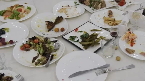 Dirty plates with leftovers on the restaurant table Stock Footage 314979304