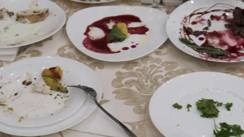 Dirty plates with leftovers on the restaurant table Stock Footage 314979306