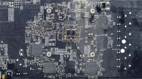 Dirty printed circuit board with chips and transistors. Stock Photos
