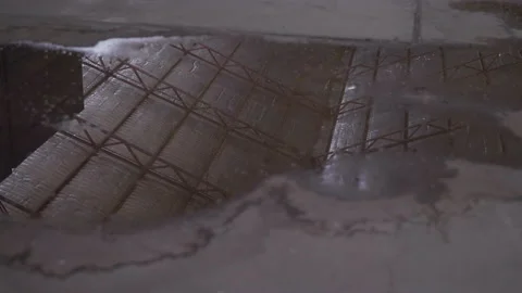 Dirty Puddle with Reflection of Old Warehouse Stock Footage 219442774