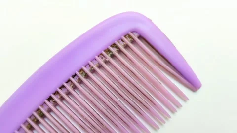 A dirty purple comb on a white background Stock Footage 313255053