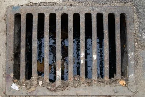 Dirty rectangular sewer or drain that installed in a street to collect rain.. 스톡 사진
