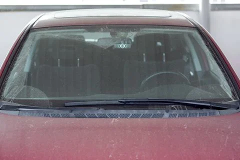 Dirty red car windscreen wipers covered with a layer of dust. Stock Photos