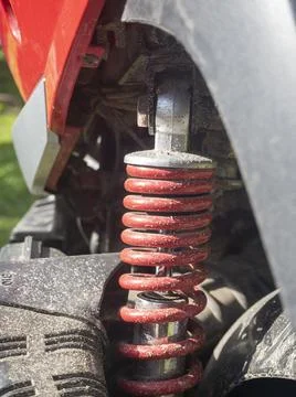 Dirty red scooter shock absorber close up Stock Photos