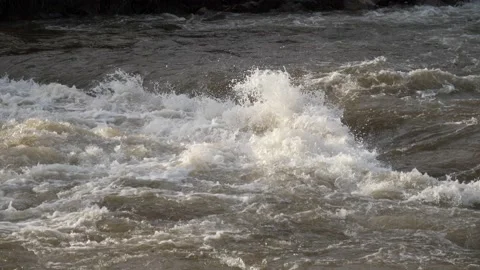Dirty river flows fast after heavy rains in autumn Stock Footage 227799542