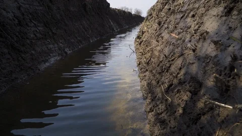 Dirty river, stream, filled with mud and waste, slow motion.  Stock Footage 127066362