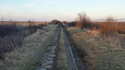 The dirty road between the fields  - drone shot moving forward Stock Footage 125053620