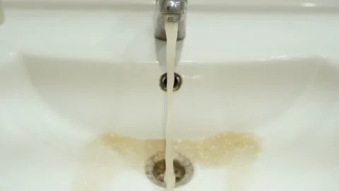 Dirty rusty water from the tap into Video stock 168922485