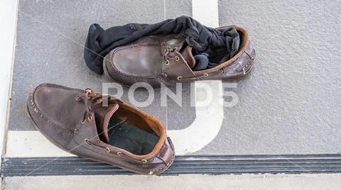 Dirty shoes and black socks on the floor in the office., shoe and sock has fo Stock Photos